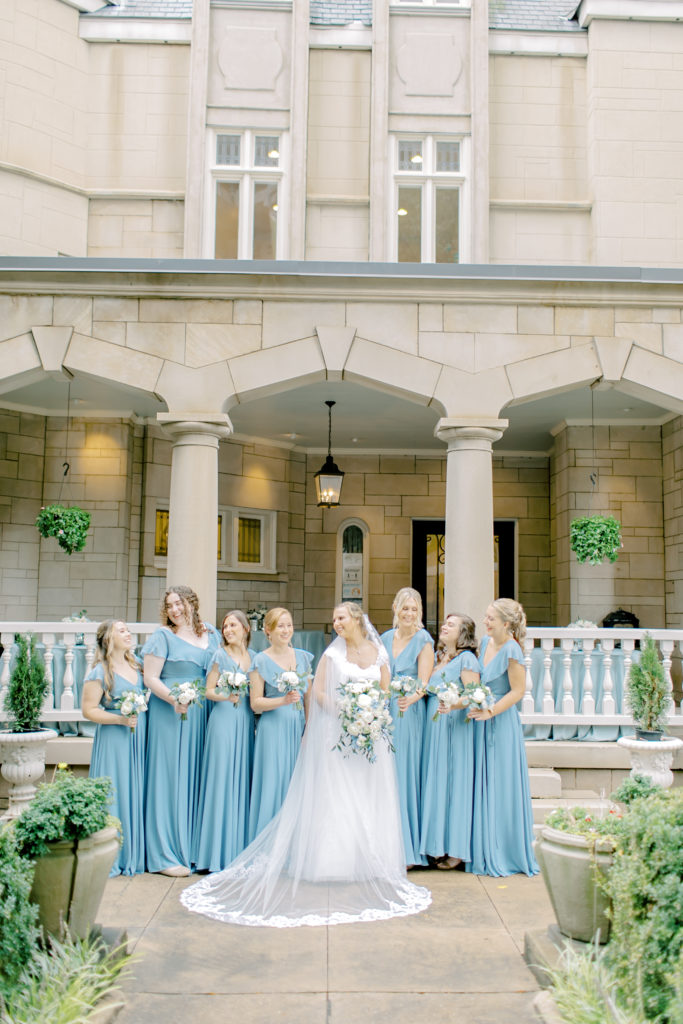 bridesmaids and bride laughing in the front of the wimbish house in atlanta georgia
