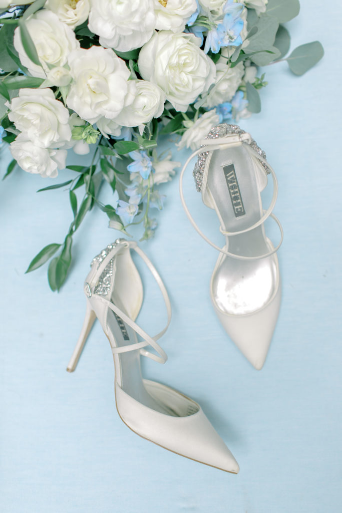 wedding shoes with wedding flowers on flat lay