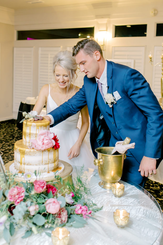 husband and wife cut their wedding cake
