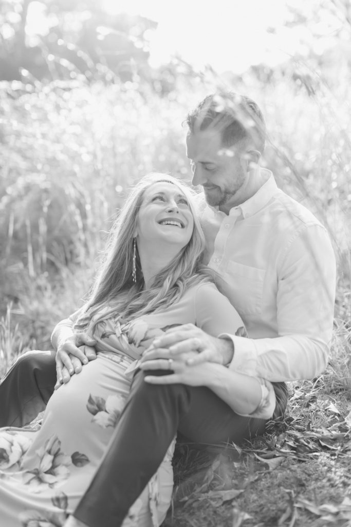 black and white maternity session photo in field