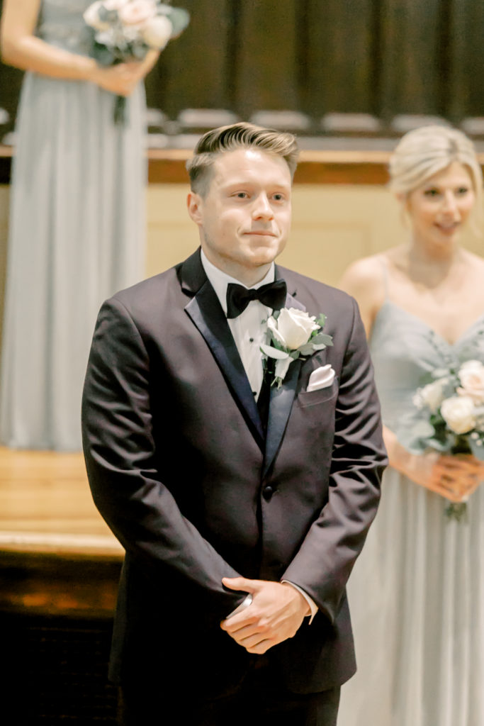 groom sees bride walking down the aisle for the first time