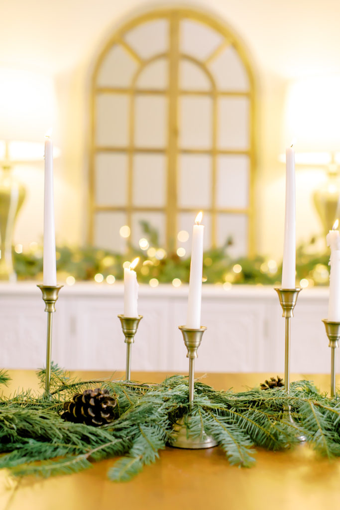 dining room table centerpiece for christmas with candlesticks and garland