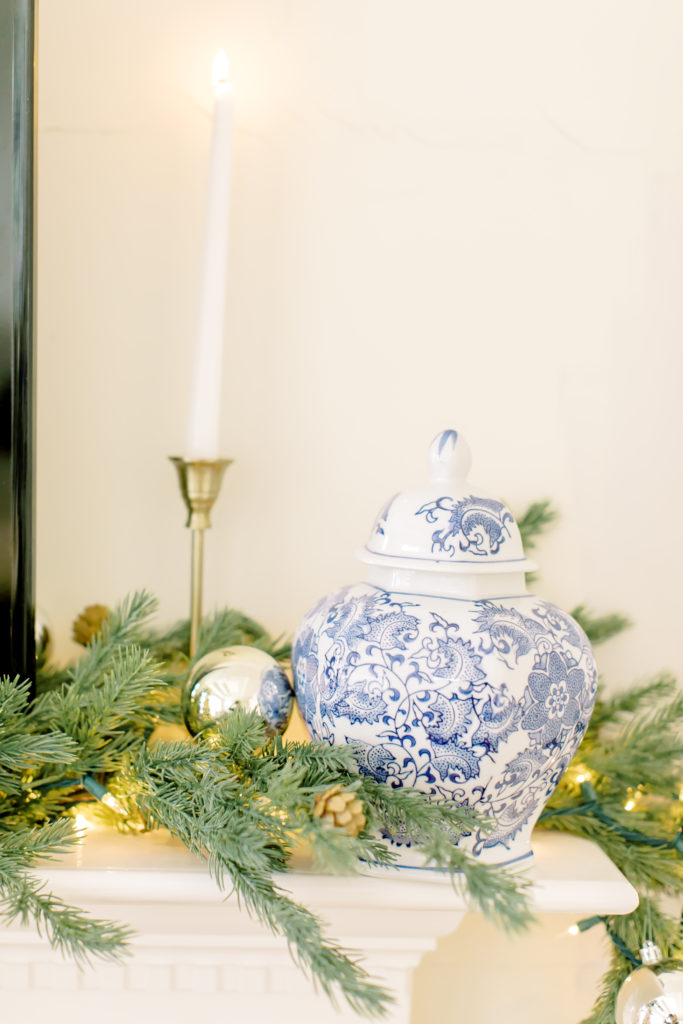 mantle christmas decor with candle stick and blue and white jar