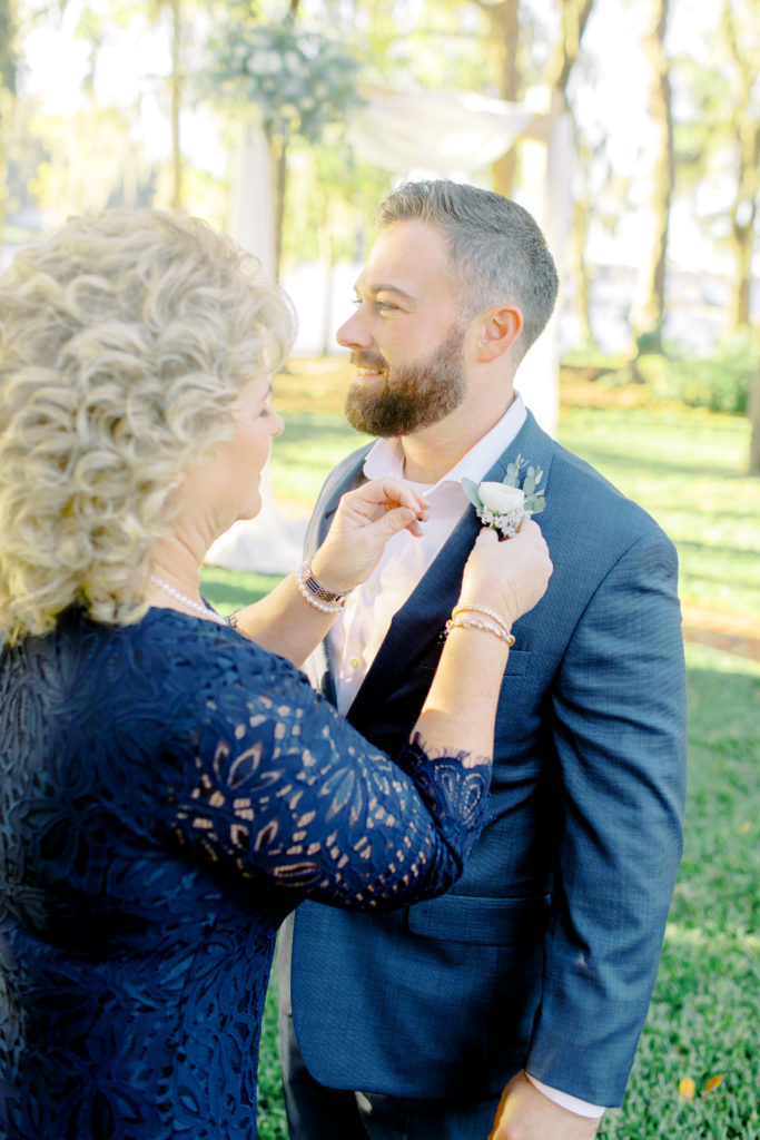 mom putting boutonniere on groom | Jacksonville, Wedding Photographer | Photo by Mary Catherine Echols