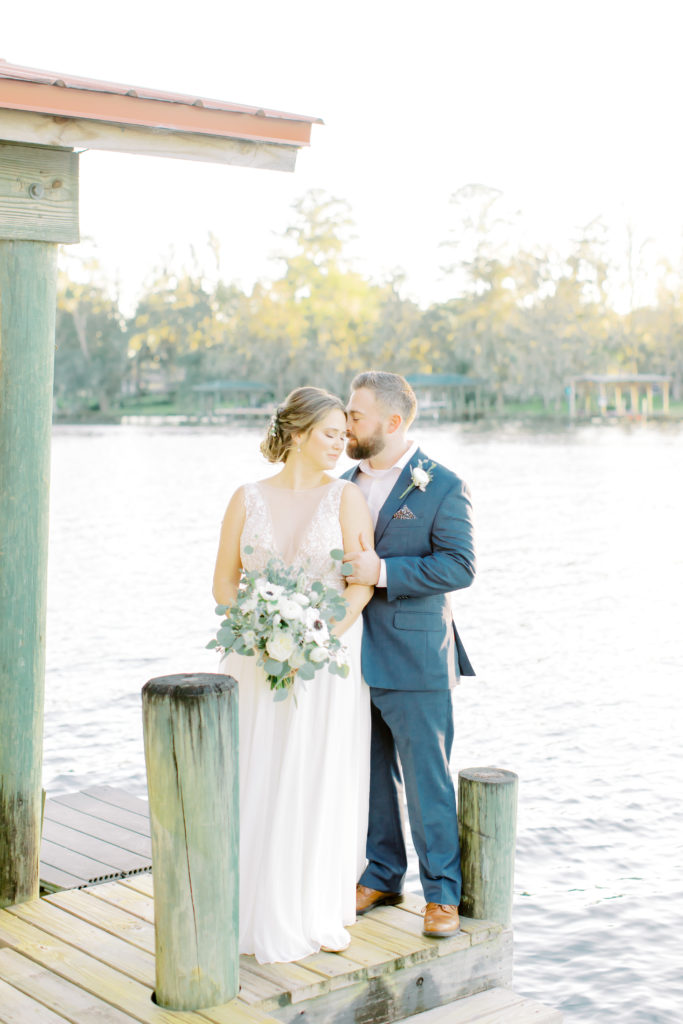 Bride and groom kiss on the end of the dock by the water | Jacksonville, Wedding Photographer | Photo by Mary Catherine Echols