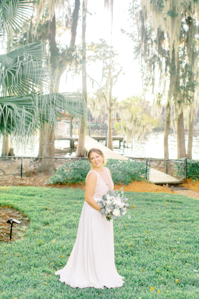Cute image of the bride laughing over her shoulder in the backyard by the river | Jacksonville Wedding Photographer | Photo by Mary Catherine Echols