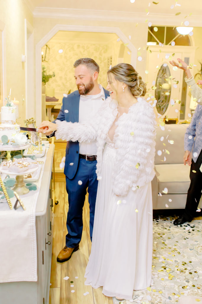 bride and groom cut the cake inside her home, mom and grandma throw confetti | Jacksonville Wedding Photographer | Photo by Mary Catherine Echols