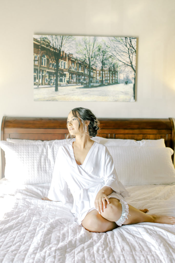 bride in her robe sitting on the bed | Photo by Mary Catherine Echols