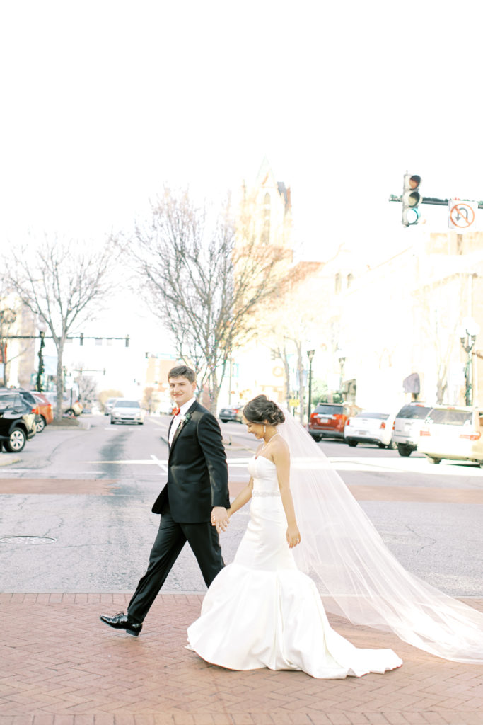 bride and groom walking across downtown anderson south carolina | Photo by Mary Catherine Echols