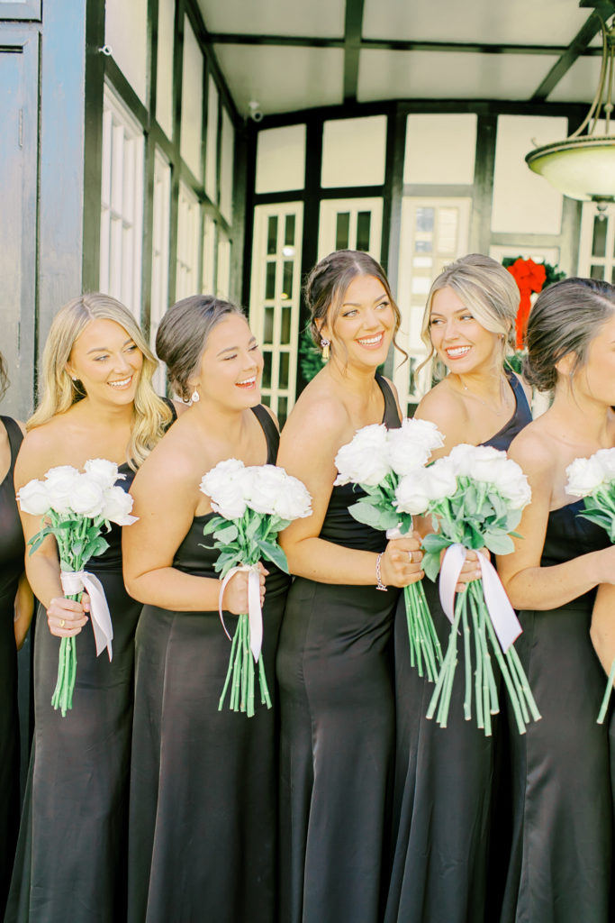 bridesmaids in black dresses and white roses | Photo by Mary Catherine Echols