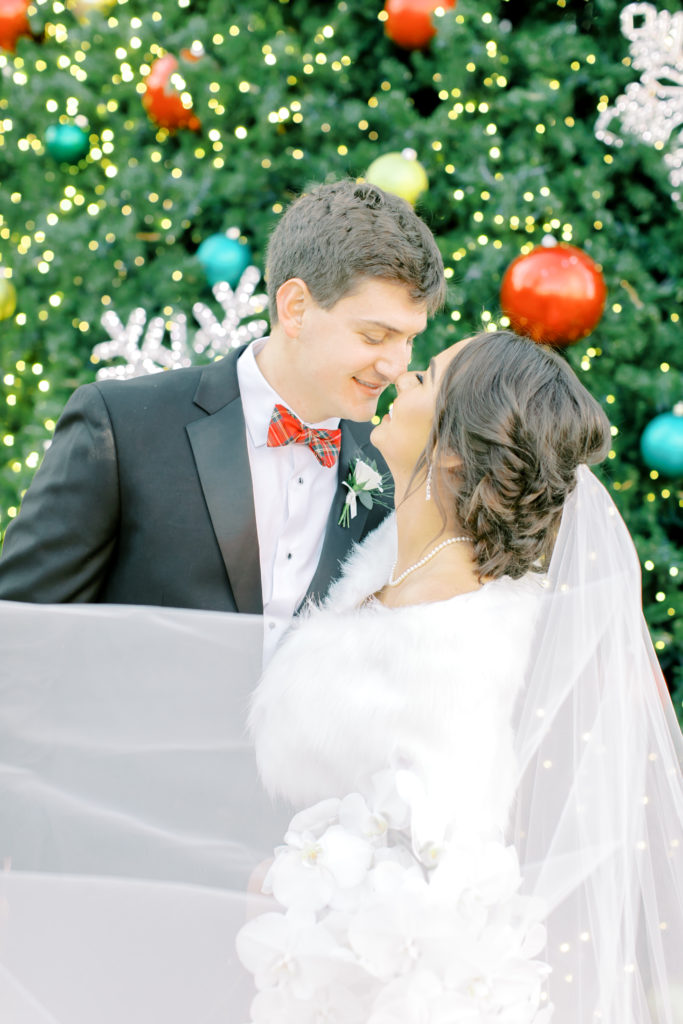 bride and groom portrait in front of the christmas tree | Photo by Mary Catherine Echols