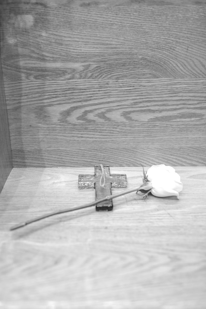 honorary white flower and glass cross sitting where bride's dad would have been | Photo by Mary Catherine Echols