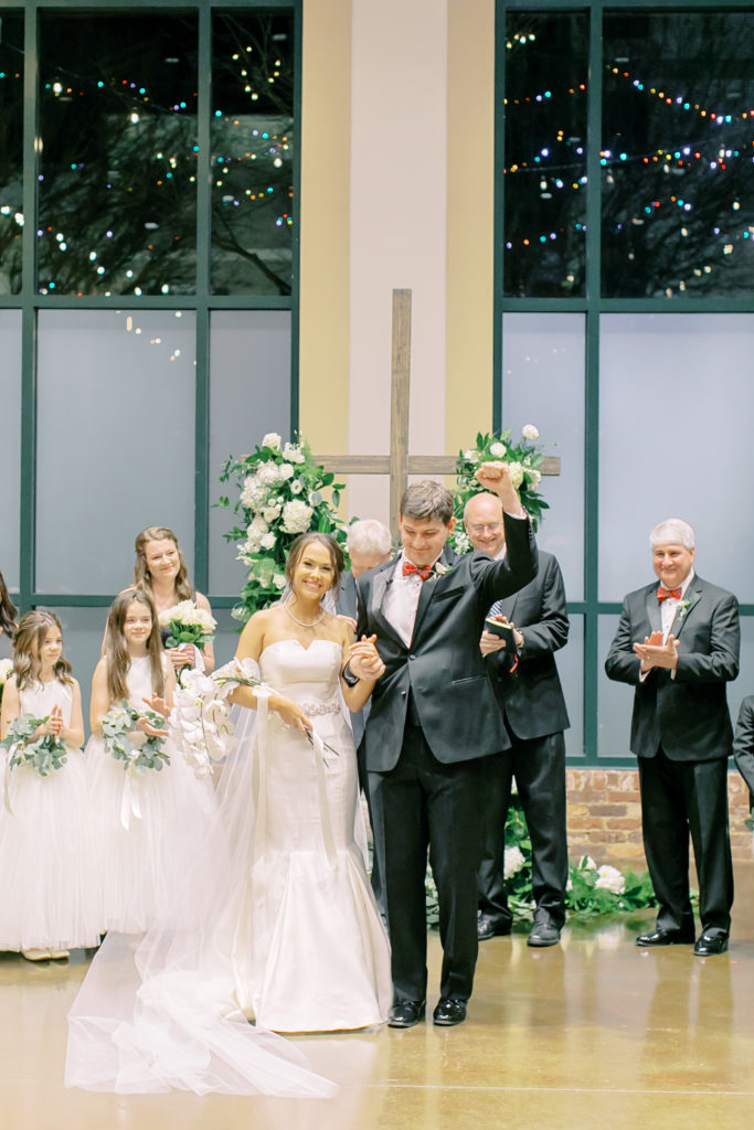 groom fist pumps, they walk down the aisle as husband and wide  | photo by mary catherine echols, a jacksonville florida based photographer