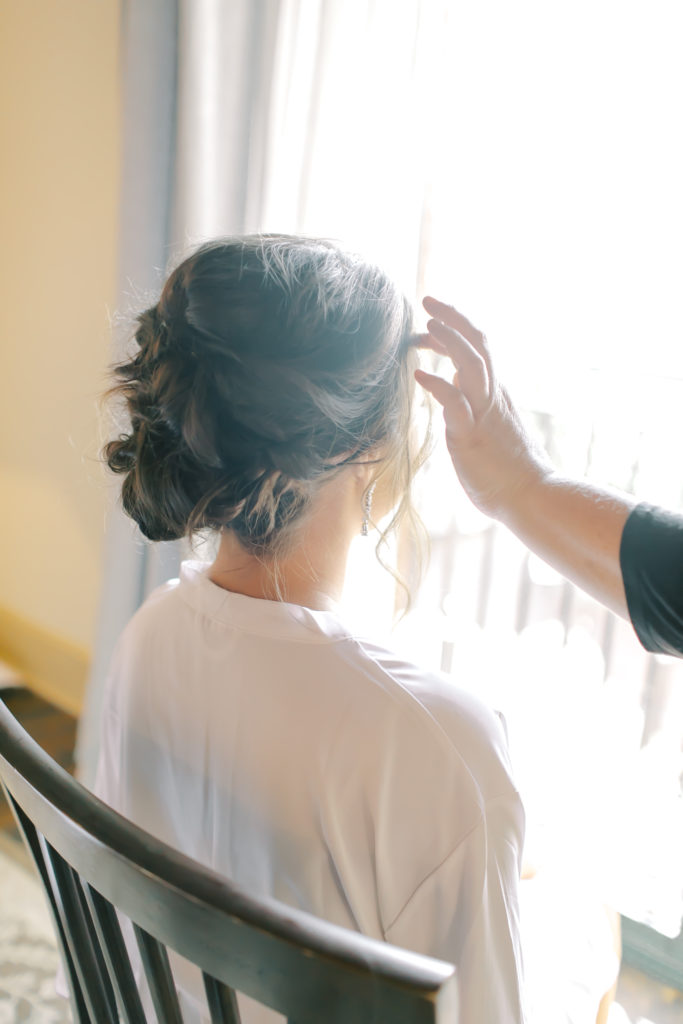 bride getting final hair and makeup touches | Photo by Mary Catherine Echols
