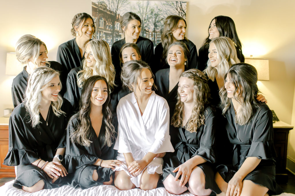 bride and her bridesmaids in their black and white robes | Photo by Mary Catherine Echols