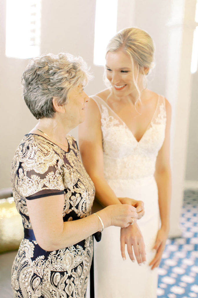 Bride helping mom put on her jewelry  | Photo by Mary Catherine Echols, a photographer based out of Jacksonville, Florida