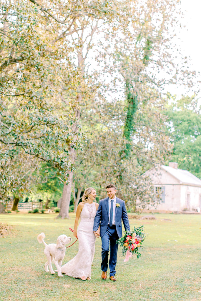husband and wife walking with their golden doodle at wavering place | photo by mary catherine echols