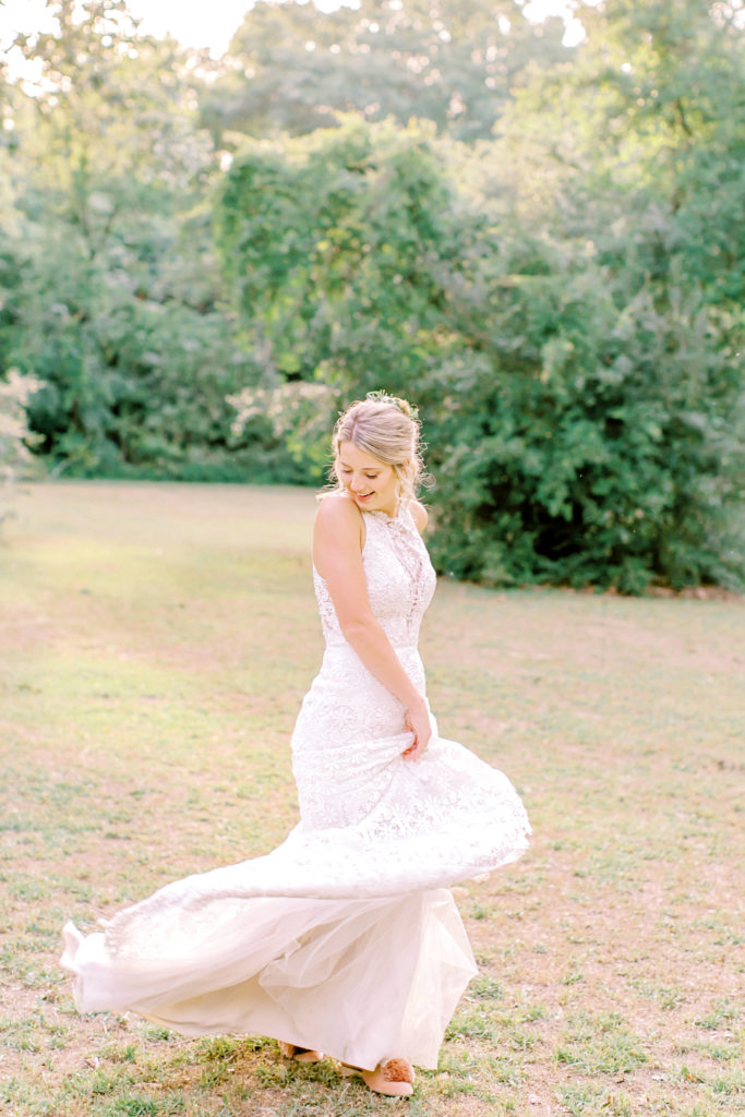 bride twirls dress in a field | photo by mary catherine echols