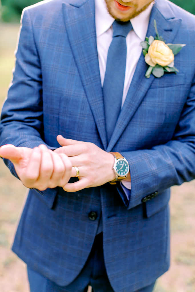 groom fixing his jacket and watch | photo by mary catherine echols