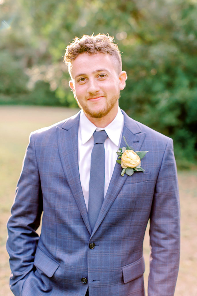 close up shot of groom in blue suit | photo by mary catherine echols