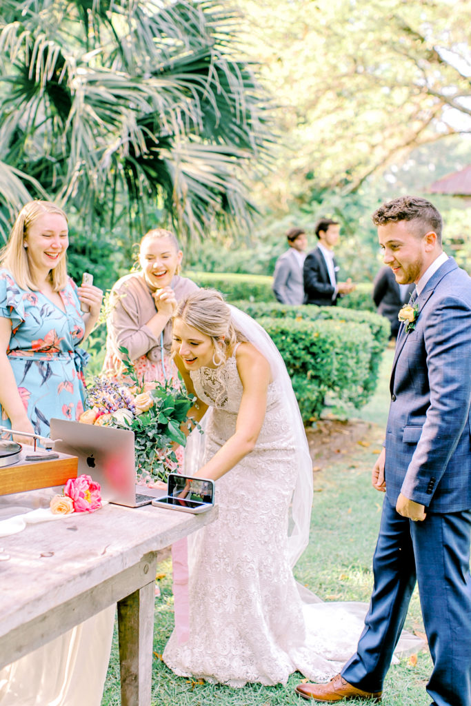 bride and groom say hello to their family and friends over facetime | photo by mary catherine echols