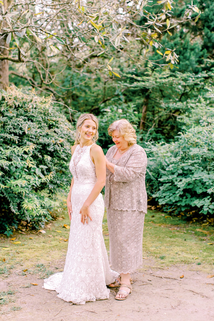 mom helping zip bride's dress | photo by mary catherine echols