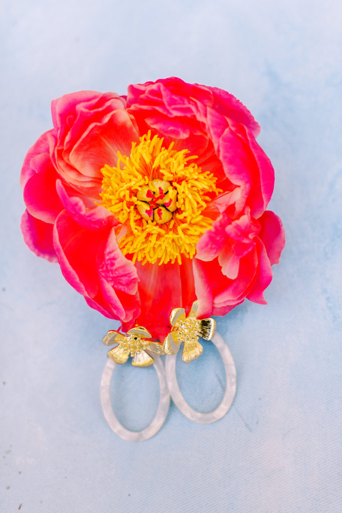 details shot, earrings rest on pink peony | photo by mary catherine echols