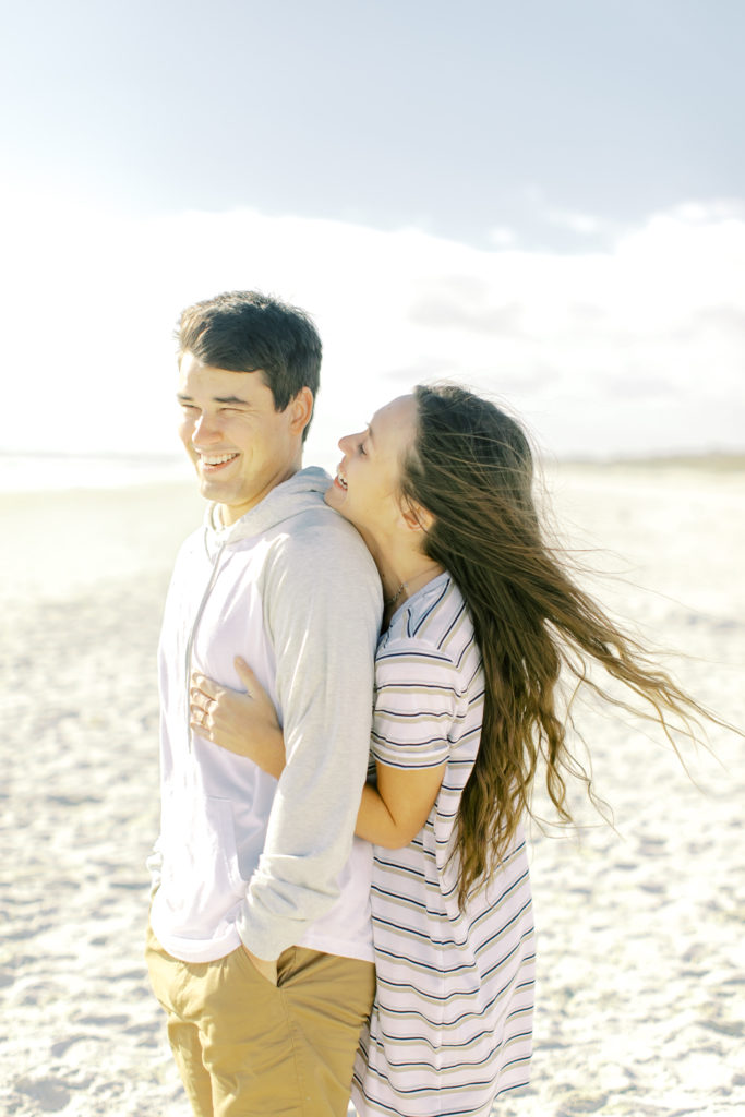 couple laughs on neptune beach florida