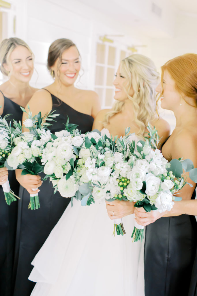bride and bridesmaids laughing at the ribault club | photo by Mary Catherine Echols, a Jacksonville based photographer