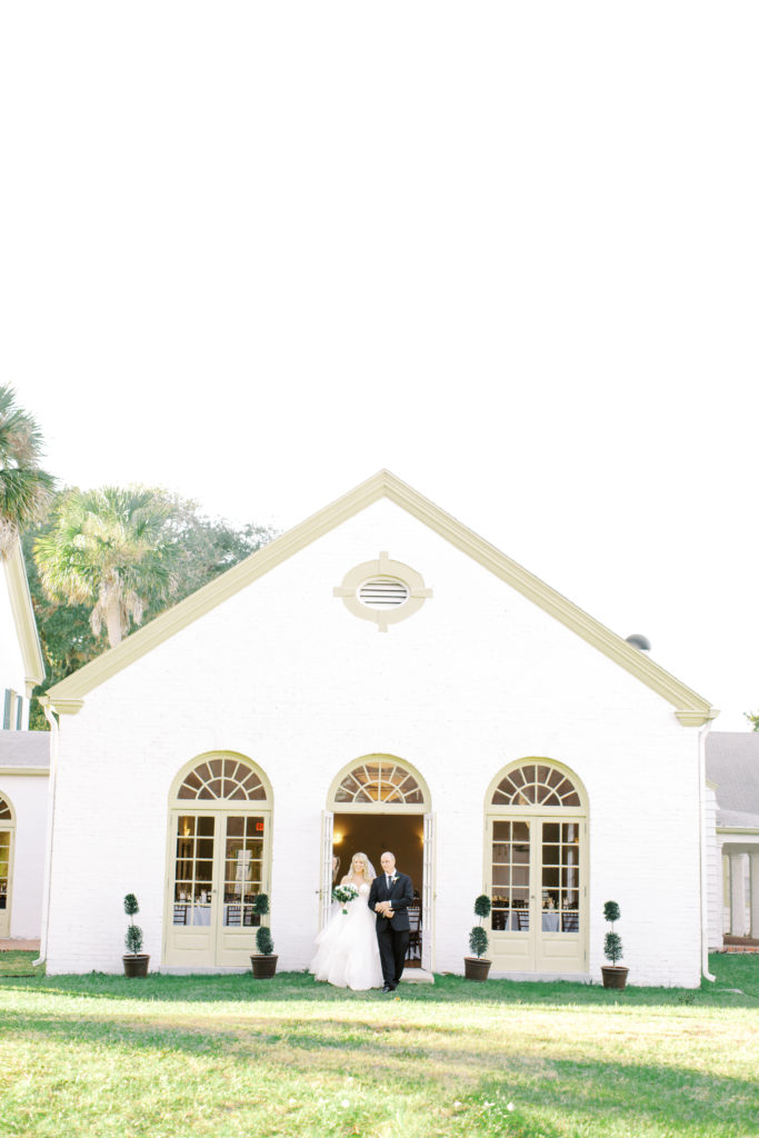 bride and dad walking to the ceremony space at the ribault club | photo by Mary Catherine Echols, a Jacksonville based photographer