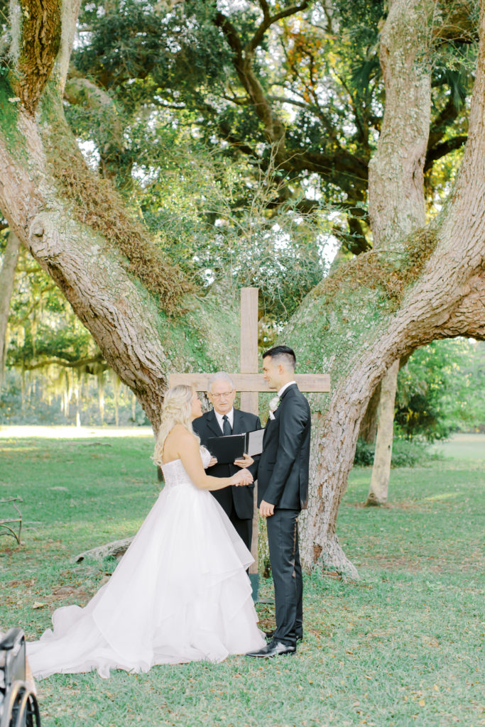 bride and groom putting rings on each other | photo by Mary Catherine Echols, a Jacksonville based wedding photographer