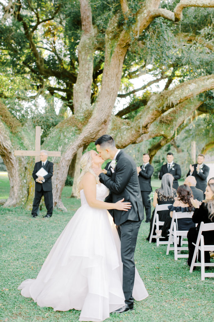 bride and groom kiss at the recessional | photo by Mary Catherine Echols, a Jacksonville based wedding photographer