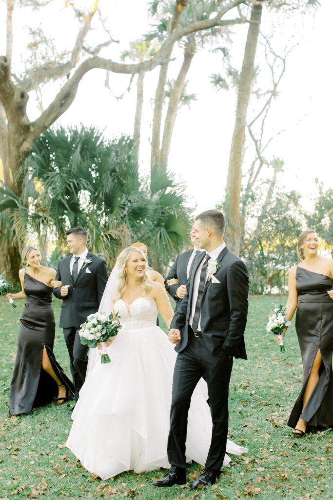 bride and groom walk with bridal party | photo by Mary Catherine Echols, a Jacksonville based wedding photographer
