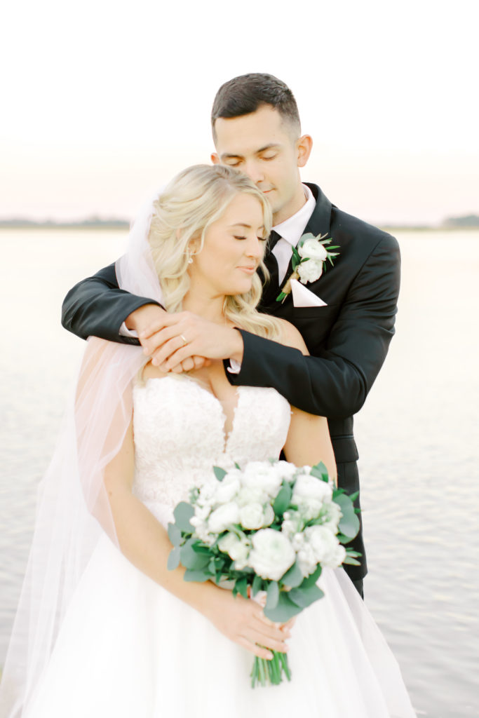 groom hugs bride, closing their eyes | photo by Mary Catherine Echols, a Jacksonville based wedding photographer