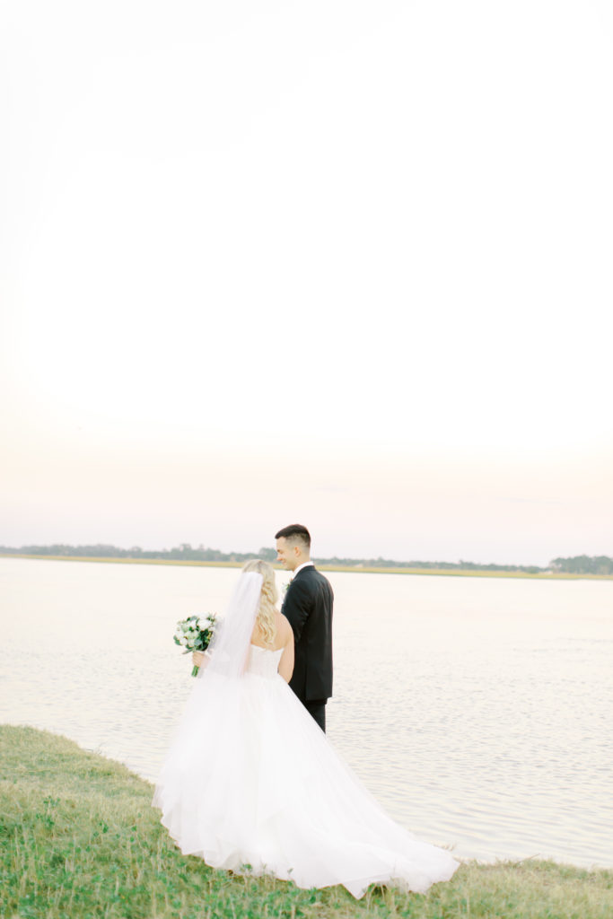 bride and groom walking along the water at the ribault club | photo by Mary Catherine Echols, a Jacksonville based wedding photographer