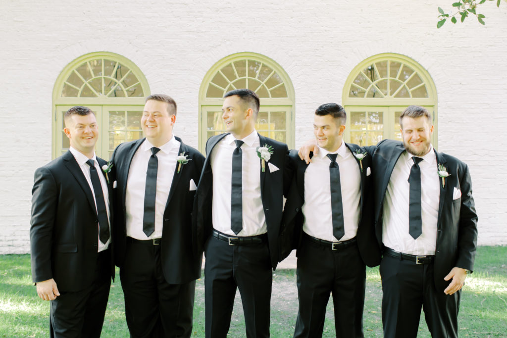 groomsment laughing at the ribault club | photo by Mary Catherine Echols, a Jacksonville based photographer