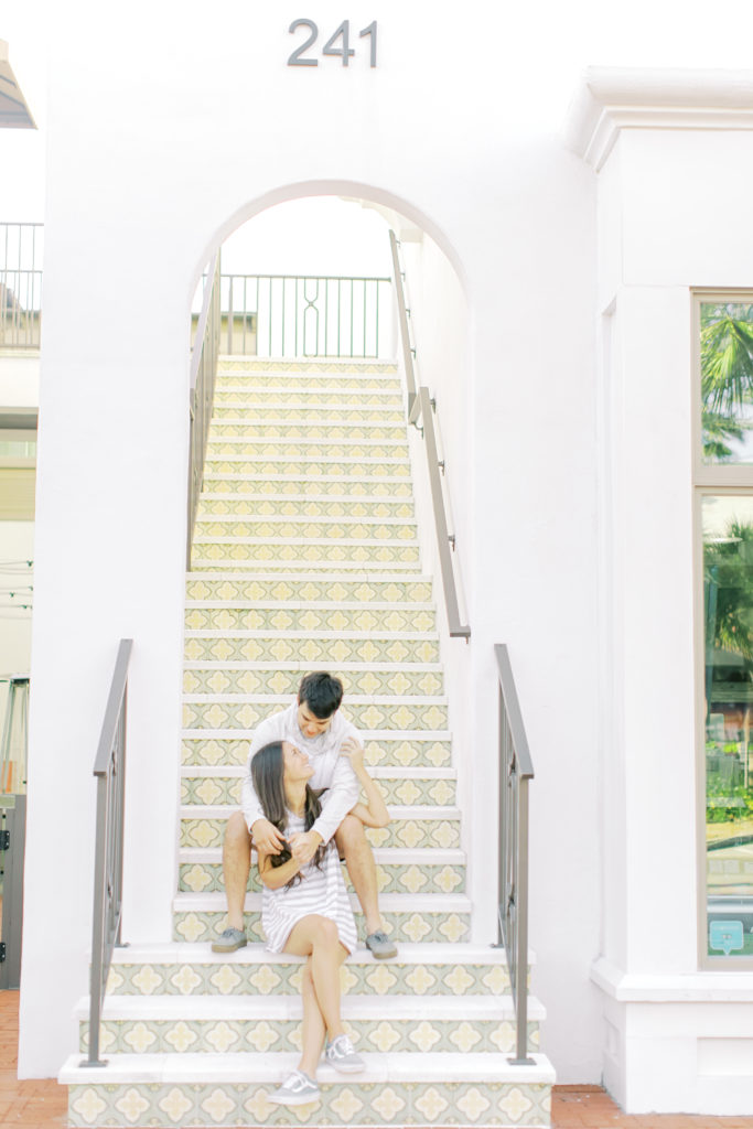couple sitting on stairs in neptune beach