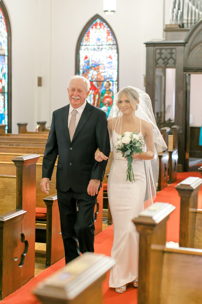 bride walking down the aisle with dad