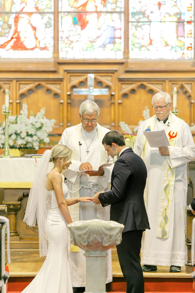 bride and groom saying vows in church