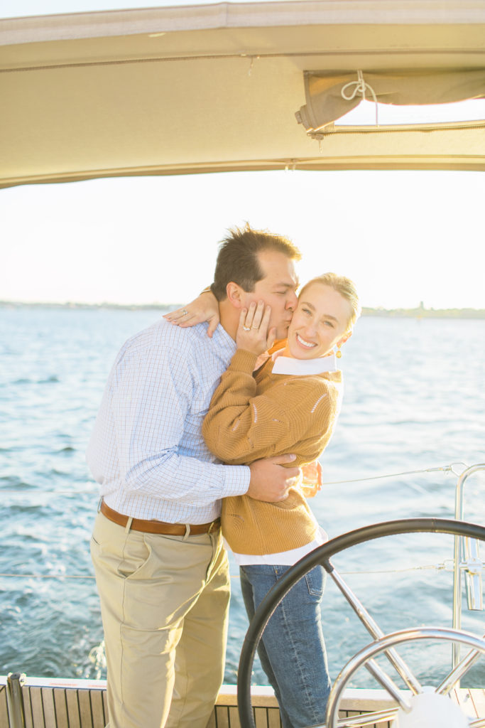 couple kissing on a sailboat