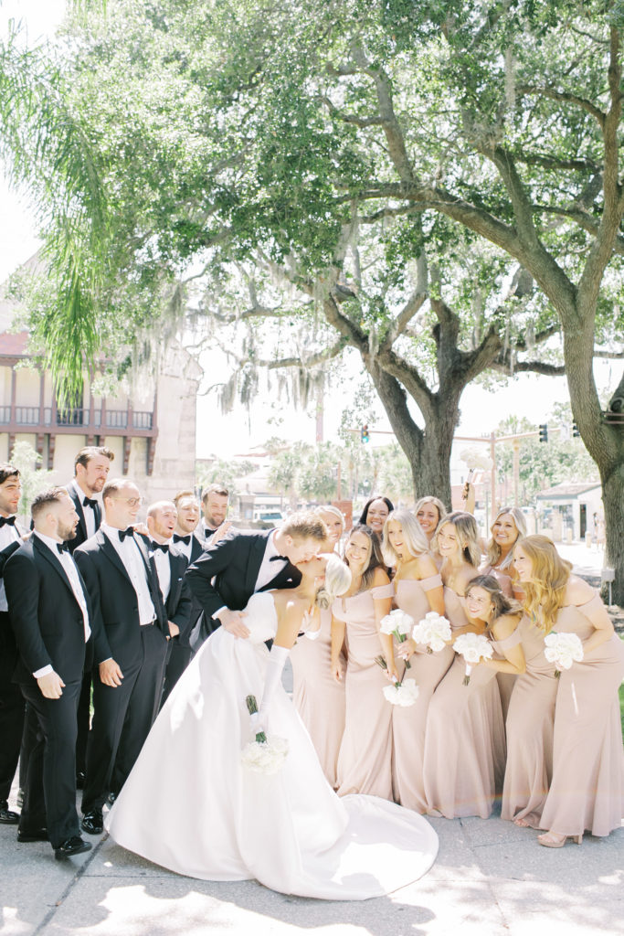 full bridal party watching the bride and groom kiss in st Augustine Florida