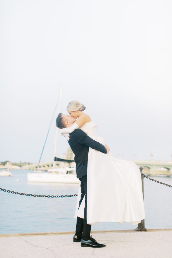 bride and groom portrait by sailboats in st Augustine Florida