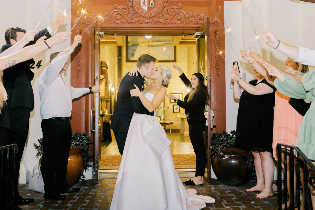 kissing goodbye at wedding reception sparkler send off